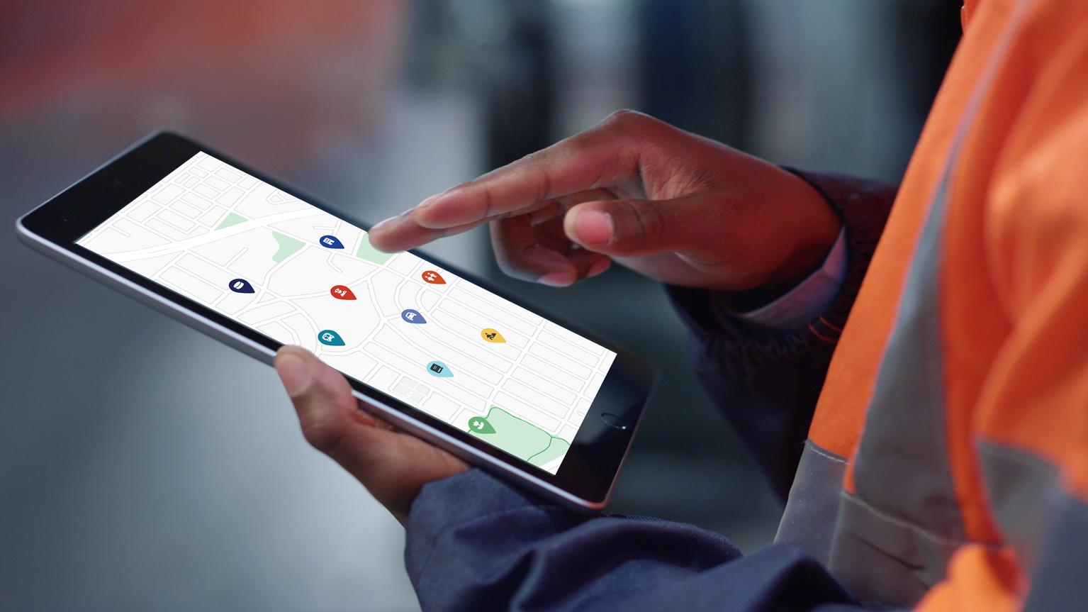 A technician looks at a tablet to complete asset inventory management work.