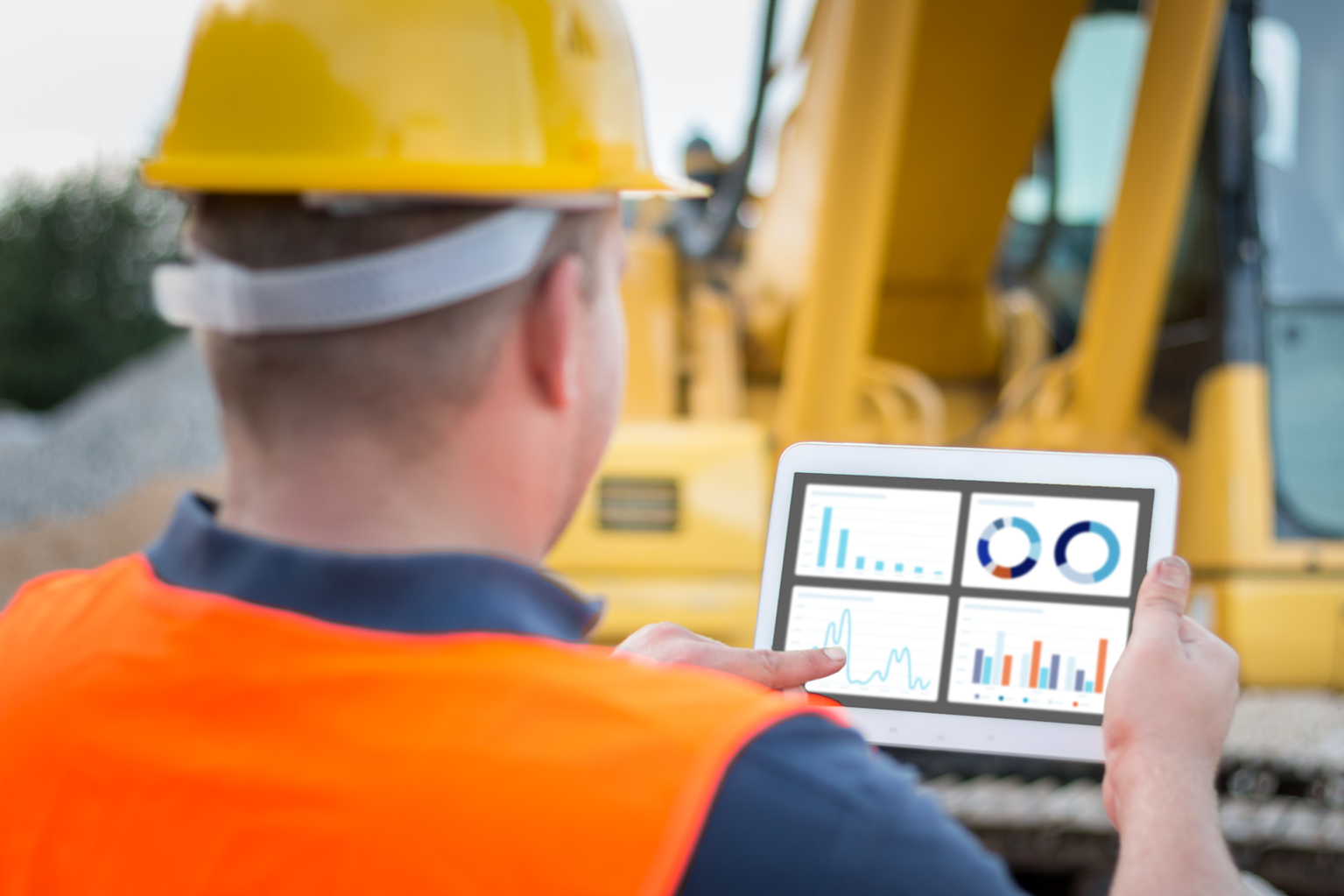 A construction supervisor looks at a capital improvement plan on a tablet.