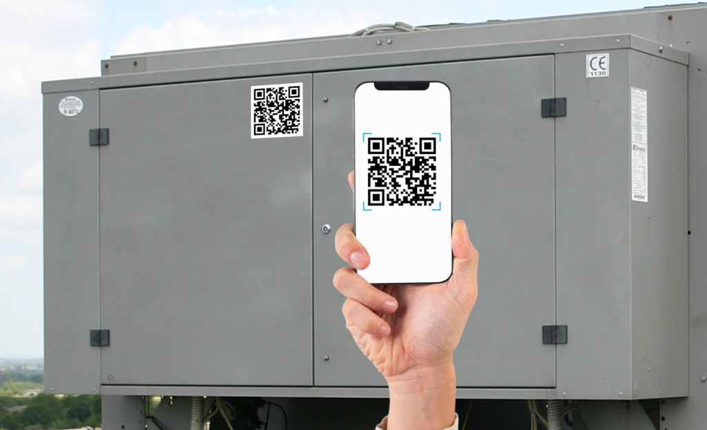 A technician holds up a phone with QR tag that's attached to an HVAC unit.