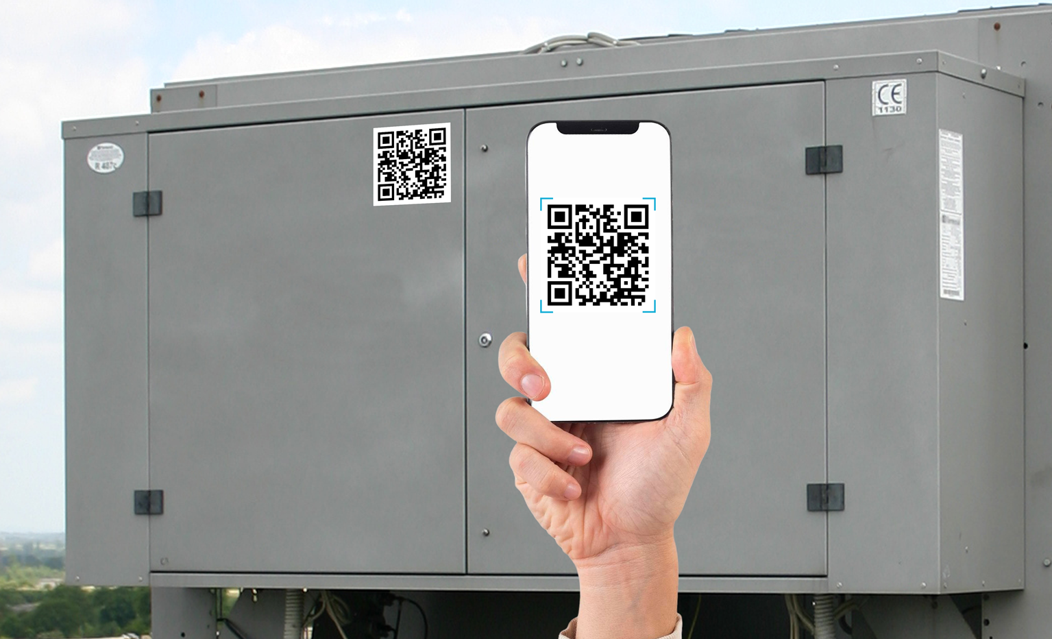 A technician holds up a phone with QR tag that's attached to an HVAC unit.